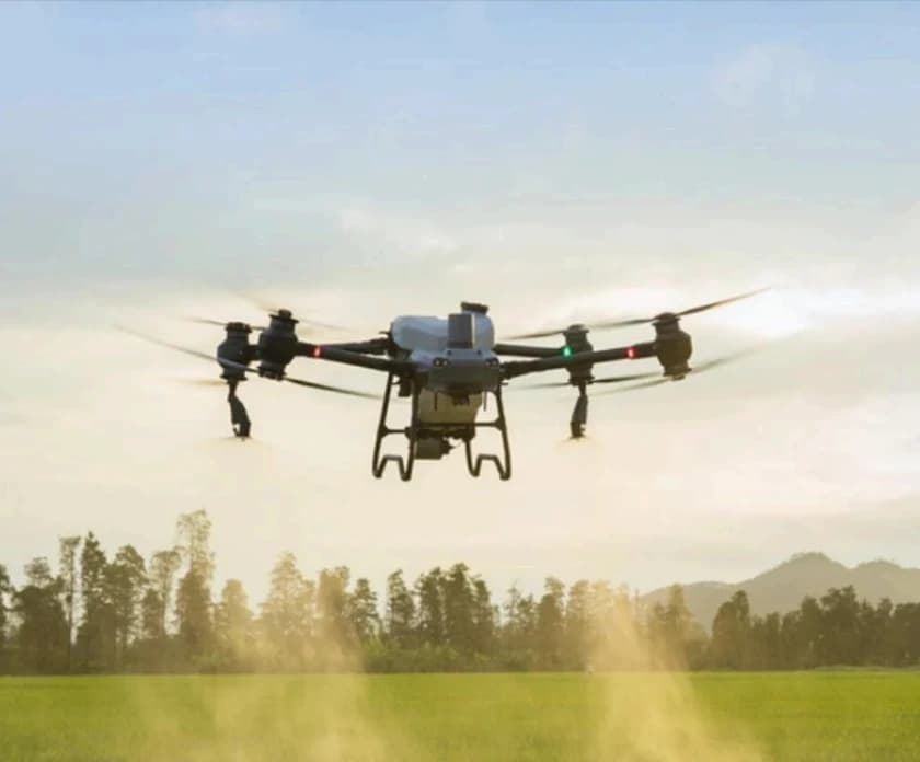 Drone spraying a field with pesticides